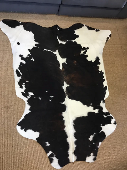 Tri colour black white and brown cow hide